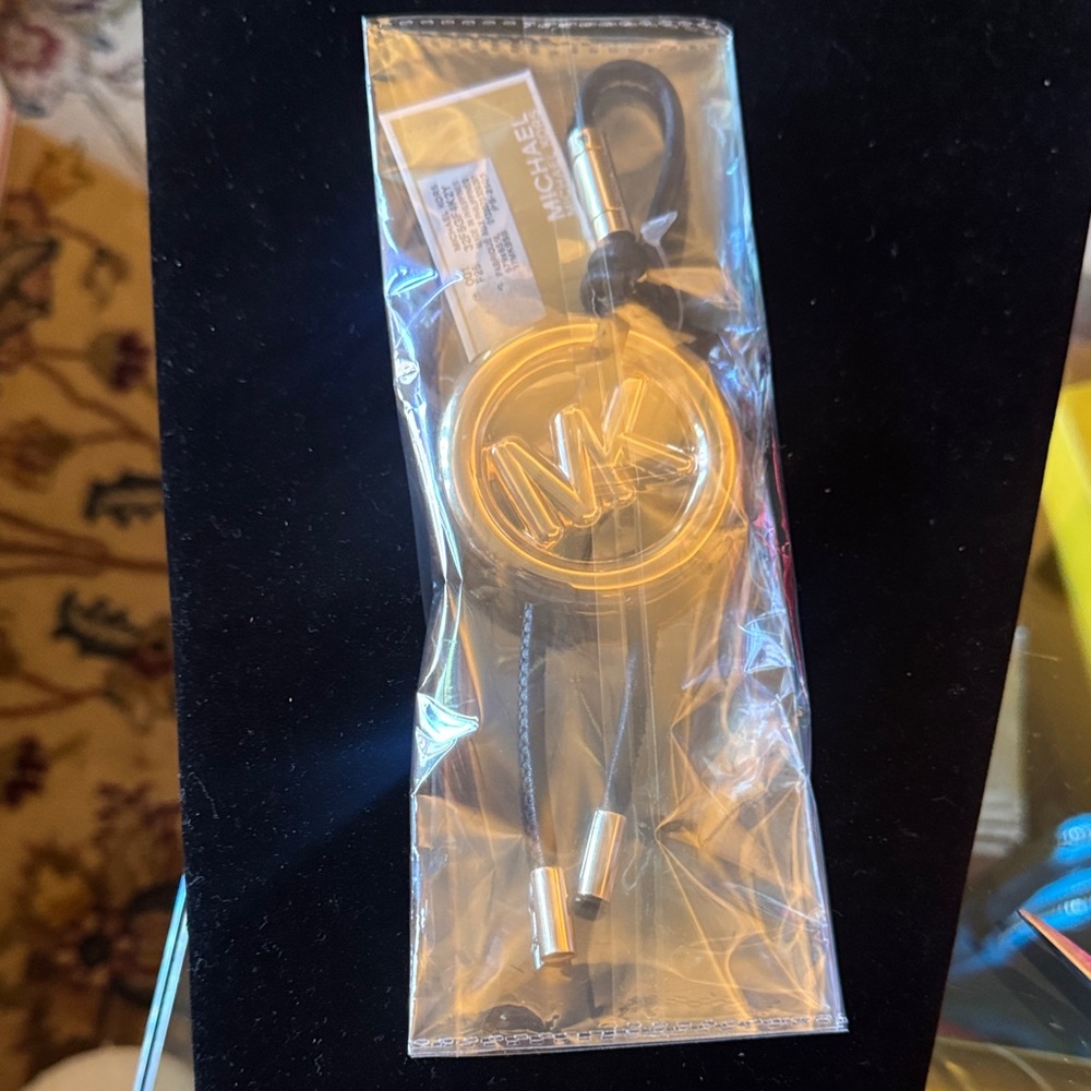 Michael Kors Gold MK Logo Phone Charm with Black Cord